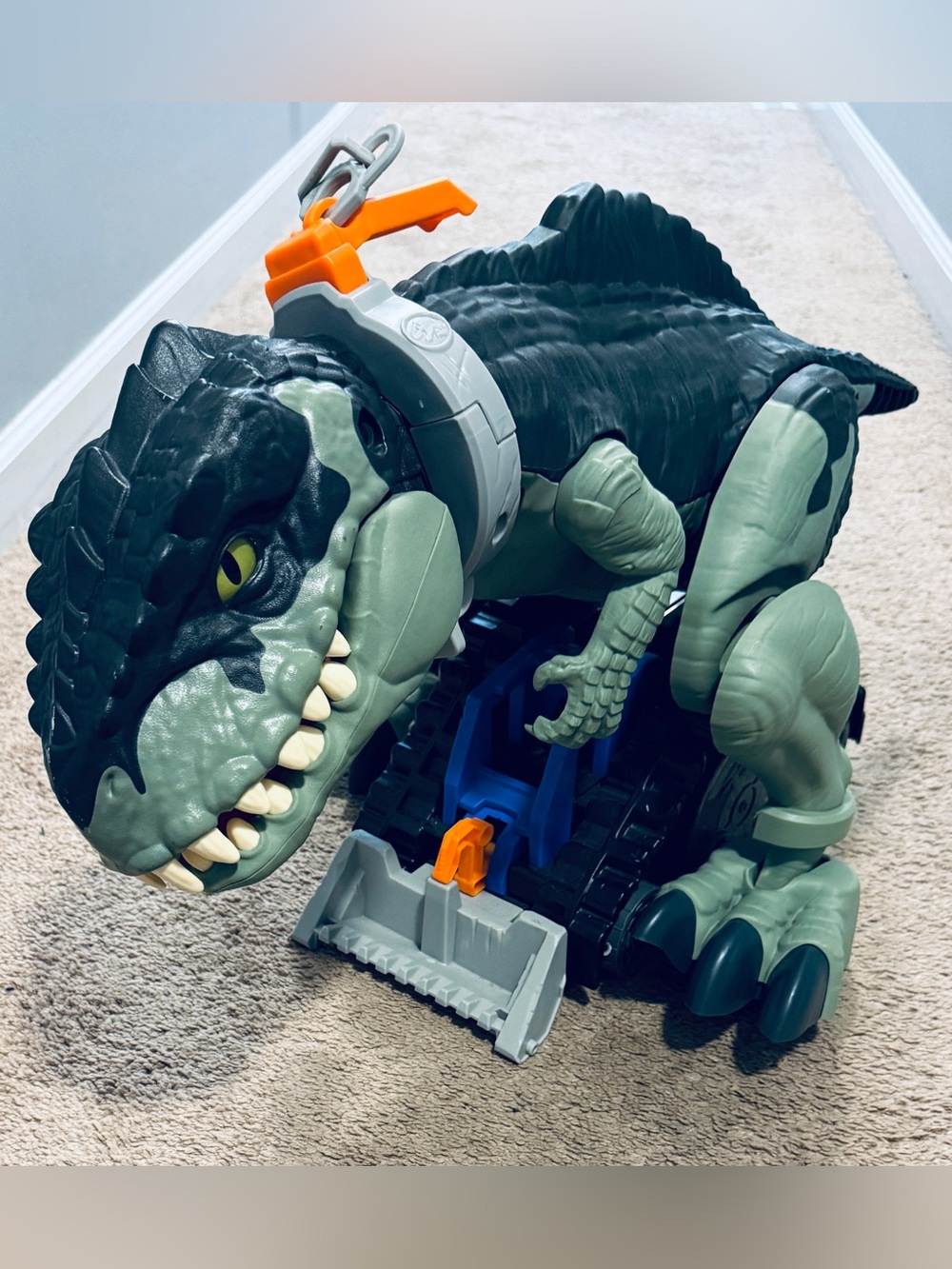 Dino bulldozer moves on wheels toy when pulled on leash chain